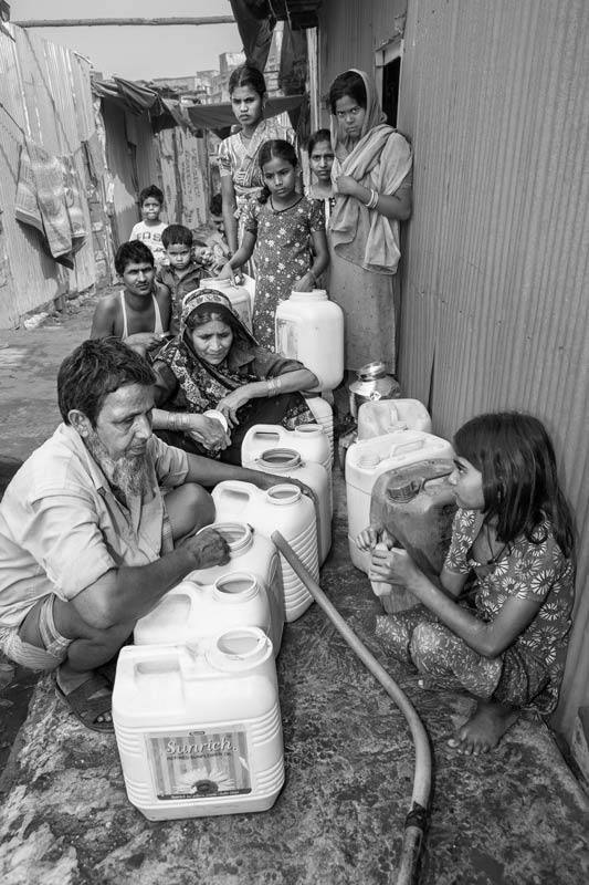 Human Right to Water in Mumbai - People in a slum waiting in uncertainty for water to arrive